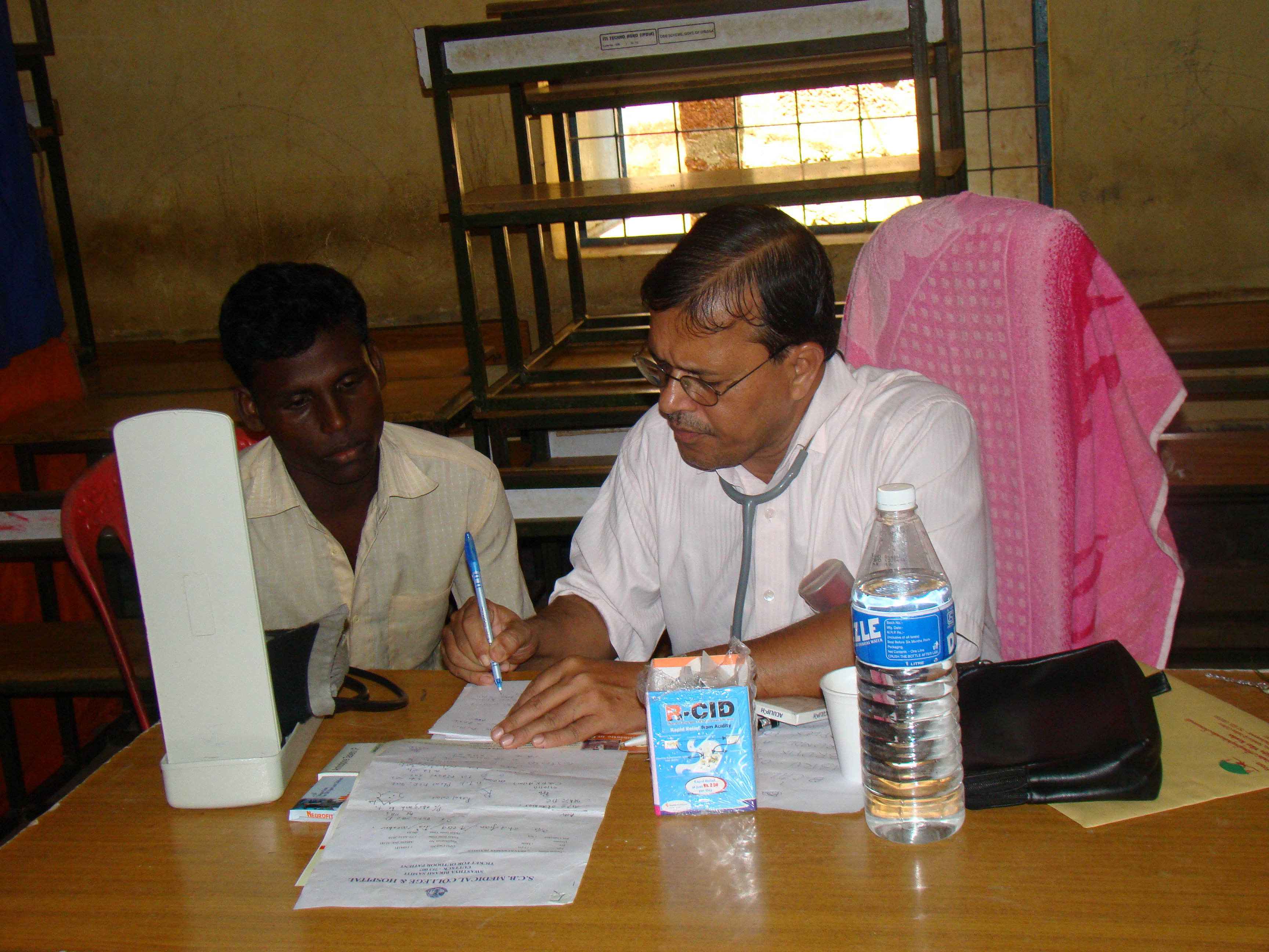 Dr. P C Mohanty attends to a patient