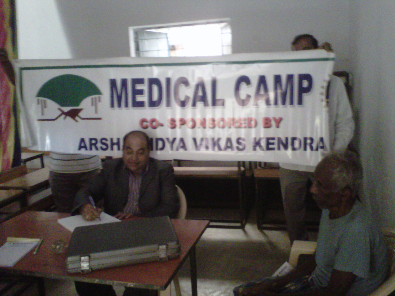 Prof. Dharanidhara Mishra attending to a patient