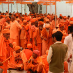 Sadhus being helped to sit for the next Batch