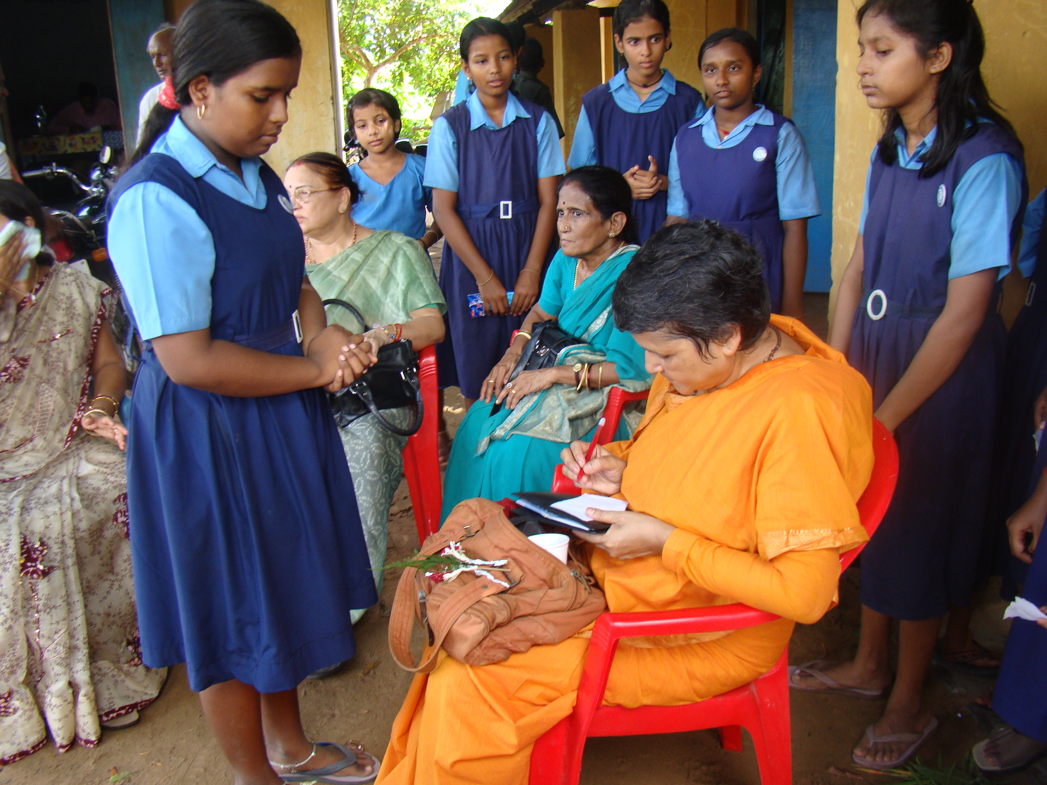 Swamini autographs for a School Girl towards end of the Camp
