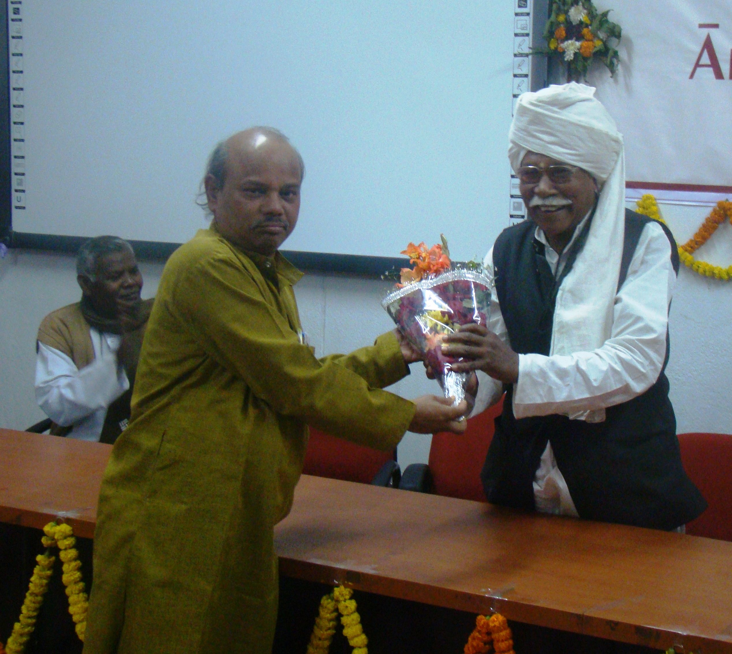 Prof. Godabarisha Mishra presenting a bouquest to Sri Birabhadra Singh