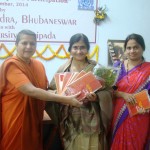 Swamini gifting her book - Rshikas of the Rgveda to the women poets