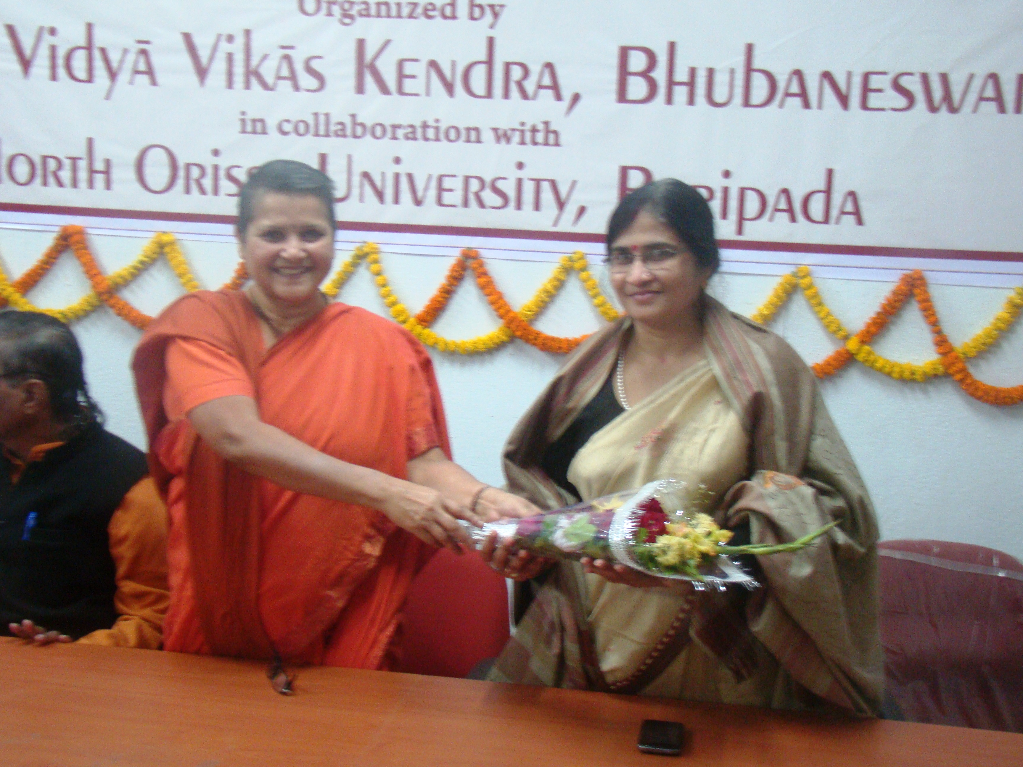 Swamini presenting a bouquet to Poet Sucharita Mohanty